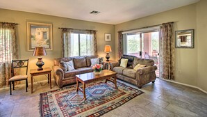 A living room with two sofas, a coffee table, a chair, and a rug. - Relaxing Green Valley Townhome ~ 30 Mi to Tucson! (Green Valley)
