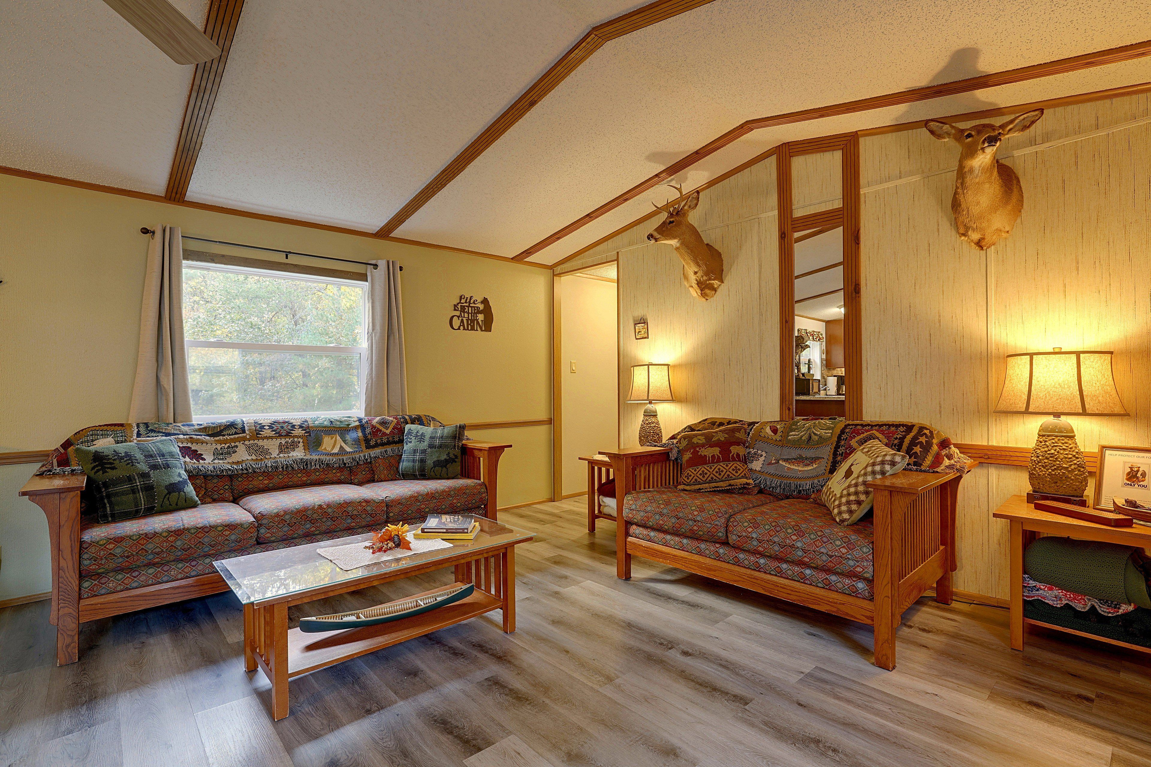 A cozy living room with a sofa, a coffee table, and a lamp.