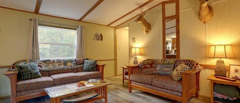 A cozy living room with a sofa, a coffee table, and a lamp.