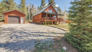 A cabin with a garage and a deck, surrounded by trees. - Near Natl Parks! Secluded Duck Creek Village Gem (Duck Creek Village)