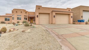 A residential building with a garage, a front door, and a driveway. - Private Pool, Spa, & Grills: Lake Havasu City Home (Lake Havasu City)