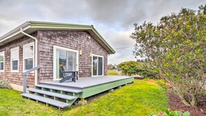 A single-story house with a front porch, a sliding glass door, and a small deck. - Steps to Beach! Airy Coastal Escape w/ Deck (Pacific Beach)