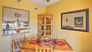 A dining area with a wooden table, chairs, and a ceiling fan. - Sun-soaked AZ Townhome w/ Private Patio & Mtn View (Green Valley)