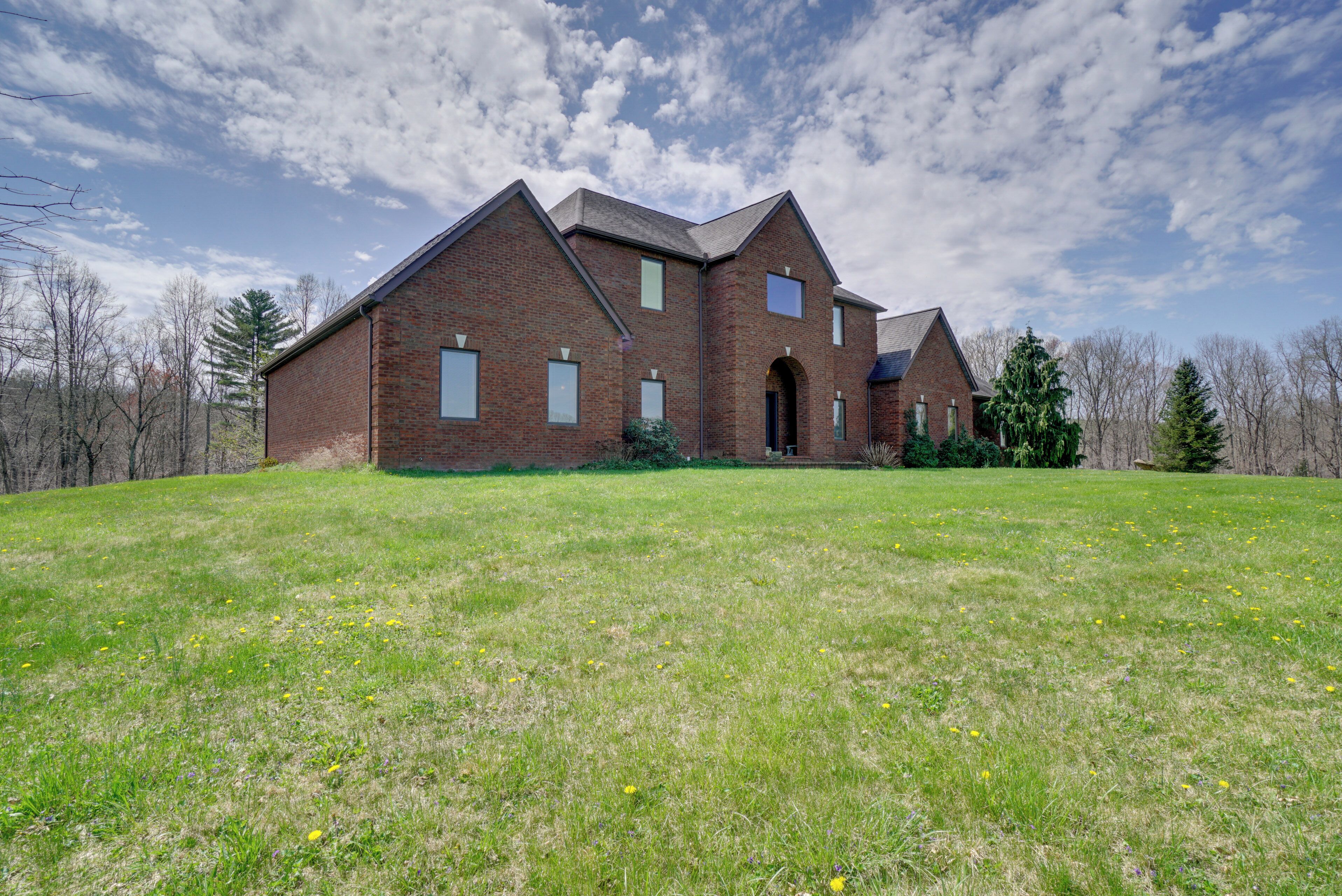 A large brick building with a symmetrical facade, multiple windows, and a central entrance.