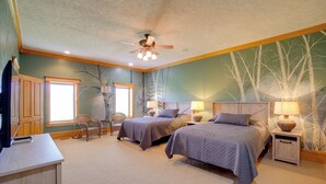 A bedroom with two beds, a ceiling fan, and a large window. - Hot Tub & Private Pond! Spacious Mcarthur Home (McArthur)