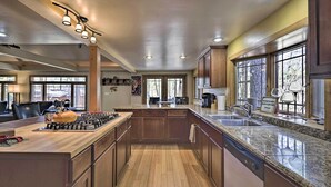 A spacious kitchen with wooden cabinets, granite countertops, and a central island. - Near Tonto National Forest: Dog-friendly Cabin! (Payson)
