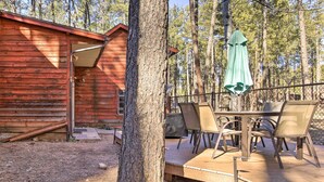 A rustic wooden cabin with a deck and outdoor seating area. - Near Tonto National Forest: Dog-friendly Cabin! (Payson)