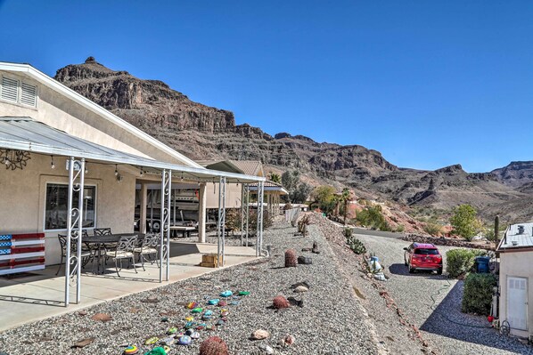 A building with outdoor seating, a covered patio, and a view of a mountainous landscape. - Sun-dappled AZ Abode w/ River & Mtn Views! (Parker)