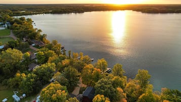 An aerial view of a lakeside property with cabins and a boat dock.