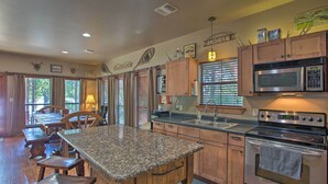 A kitchen with granite countertops, wooden cabinets, a built-in microwave, and an oven.