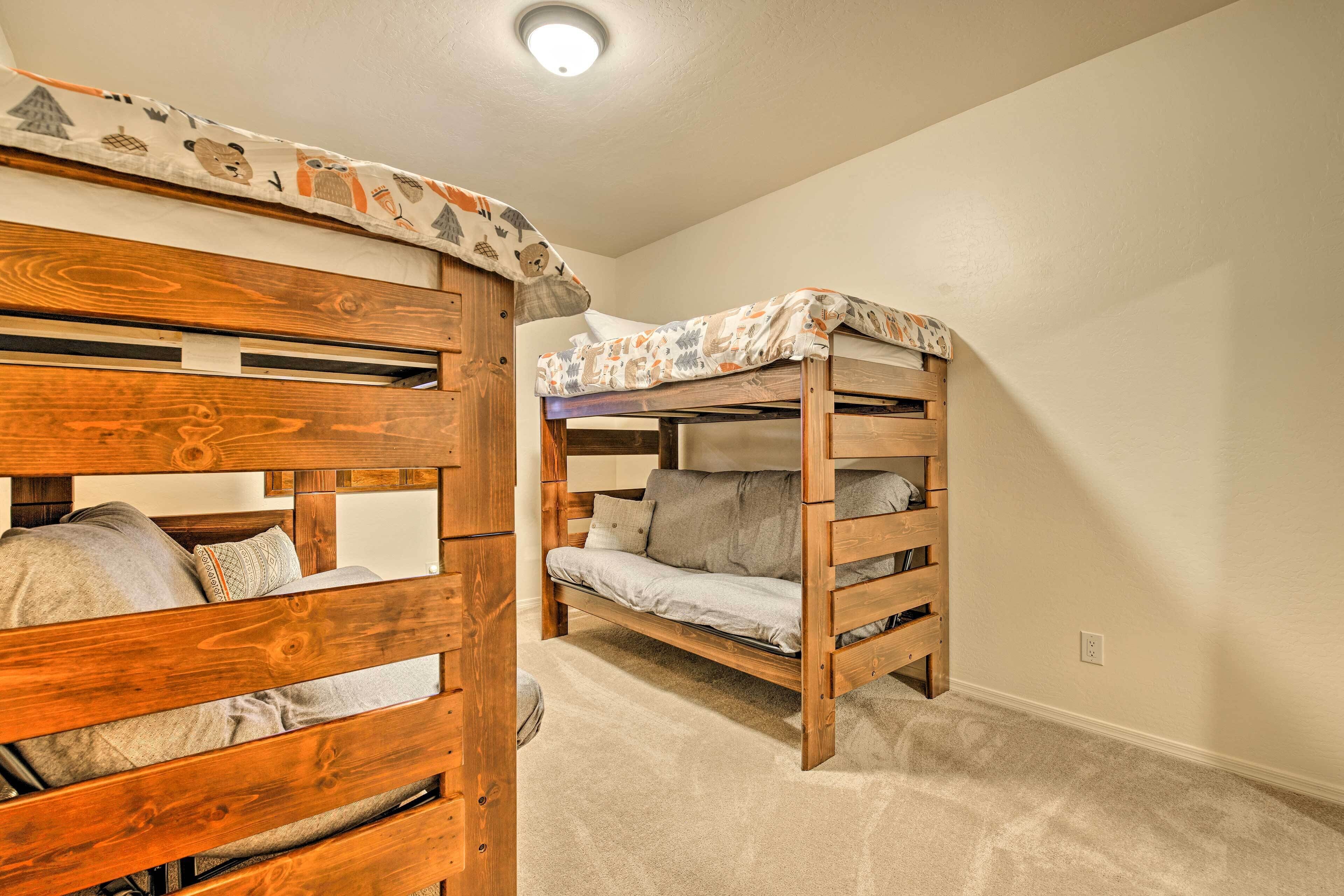 A bunk bed room with a wooden headboard and a patterned bedspread.