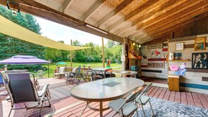 An outdoor patio area with a table, chairs, and a barbecue grill. - Southeast Michigan Escape w/ Outdoor Fun (Adrian)