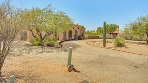 A building with a brick facade and arched windows, surrounded by desert vegetation and a gravel driveway. - 'bear Canyon Casa' - Tucson Home Base w/ Mtn Views (Tucson)