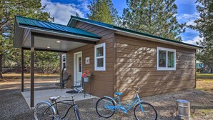A small, single-story building with a covered porch and a bicycle parked outside. - Pet-friendly Libby Cottage w/ Mountain Views! (Libby)