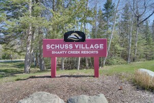 A sign for Schuss Village Shanty Creek Resorts.