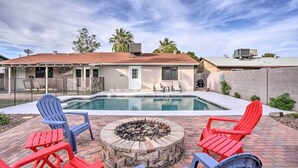 A backyard with a swimming pool, a fire pit, and outdoor seating. - Phoenix Family Home w/ Pool + Playground! (Phoenix)