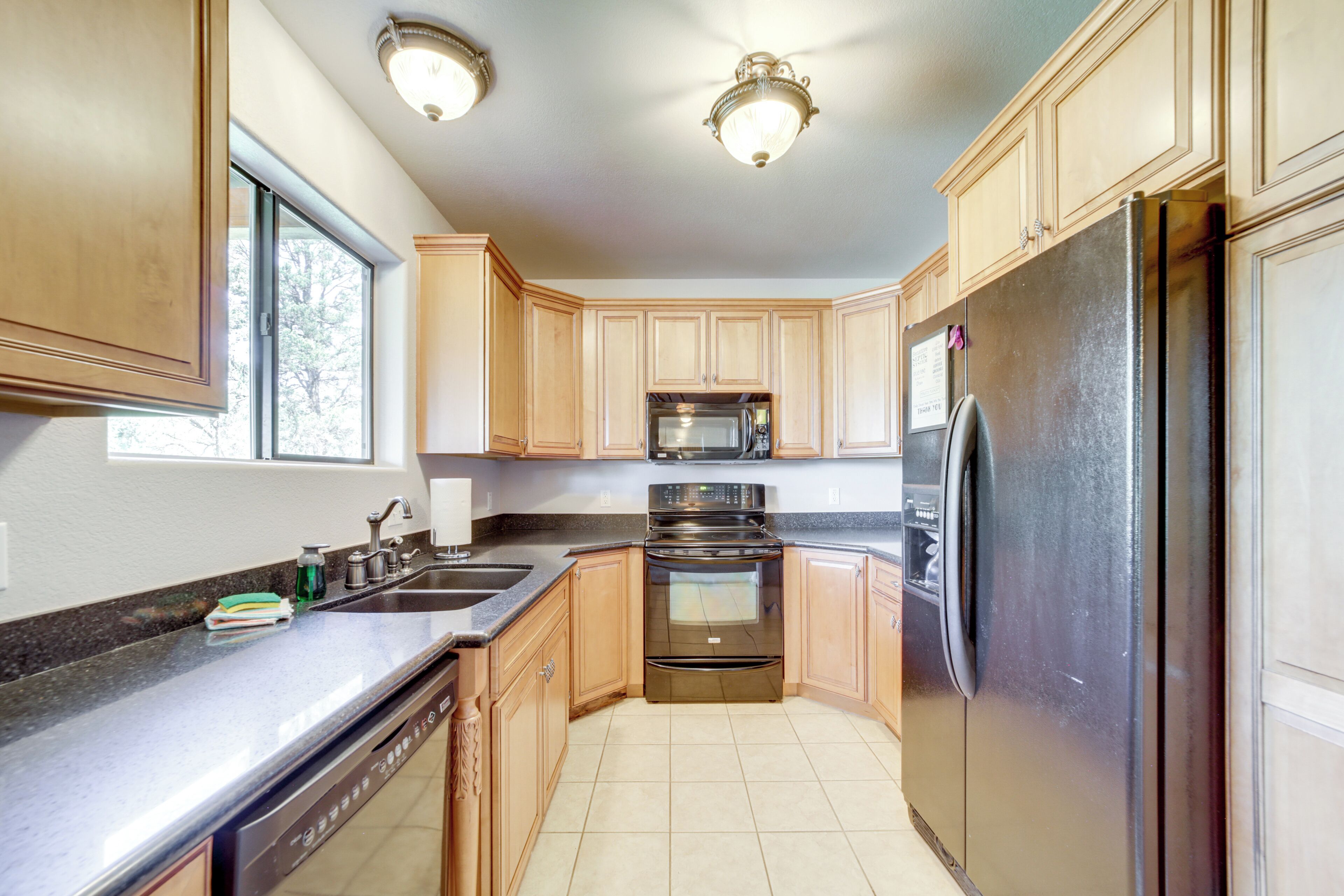 A kitchen with wooden cabinets, stainless steel appliances, and a dishwasher.