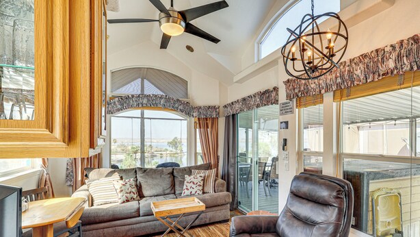 A spacious living area with a sofa, a leather chair, and a dining table. - Boat Launch + Mtn Views: Lake Havasu Cabin (Lake Havasu City)