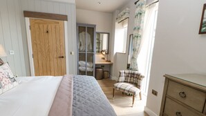 A bedroom with a bed, a dresser, a chair, and a desk. - Bolton Cottage (Appleby-in-Westmorland)
