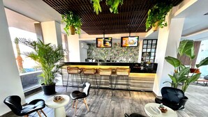 A modern bar area with a wooden ceiling, black bar stools, and potted plants. - Tranquil Haven in North Al Ahyaa, Hurghada (Hurghada)