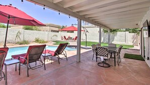 A covered patio area with a pool, outdoor furniture, and a stone-tiled floor. - Hot Tub! Family-friendly Home, 8 Mi to Westgate (Glendale)