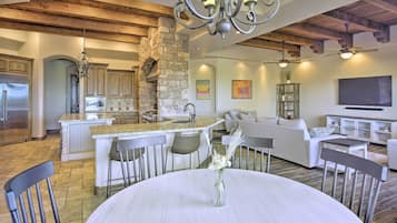 A spacious living area with a kitchen, dining table, and seating.