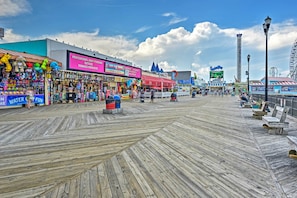 A boardwalk with shops, a Ferris wheel, and a water slide.