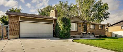 A single-story house with a garage, a small front yard, and a brick exterior.