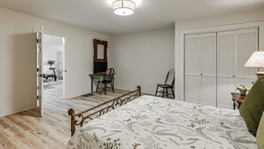 A bedroom with a bed, a desk, a chair, a wardrobe, and a mirror. - Ski & Unwind Fireside: Highlands Gem w/ Game Room! (Highlands)