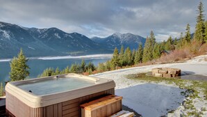 A hot tub in a mountainous area with a view of a lake and snow-covered mountains. - Dazzling Cle Elum Home; Mountain Views (Cle Elum)