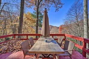 A wooden deck with a table and chairs, surrounded by trees and a clear sky. - 'cattail Creek' Escape, 44 Mi to Mt Mitchell! (Burnsville)