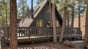 A cabin with a wooden deck, large windows, and a chimney. - Deck & Forest Views: Munds Park A-frame Cabin (Munds Park)