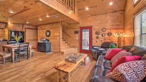 A wooden interior with a dining area, a sofa, and a staircase. - Hot Tub: 'little Bear's Pond' Broken Bow Cabin (Broken Bow)
