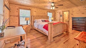 A wooden cabin bedroom with a bed, desk, chair, and dresser. - Hot Tub: 'little Bear's Pond' Broken Bow Cabin (Broken Bow)