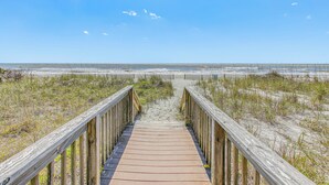 A wooden boardwalk leading to a beach with sand dunes and sparse vegetation. - 3 Mi to Broadway at the Beach: Oceanfront Getaway! (Myrtle Beach)