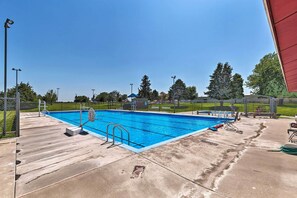 A rectangular swimming pool with a blue interior, surrounded by a concrete deck. - Elwood Townhome w/ Patio - 7 Mi to Johnson Lake (Elwood)
