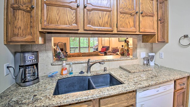A kitchen with wooden cabinets, a granite countertop, a built-in dishwasher, and a coffee maker. - 3 Mi to Golf: Hot Springs Village Retreat w/ Deck (Hot Springs Village)