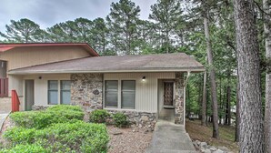 A two-story house with a stone facade, a covered porch, and a stone pathway leading to the entrance. - 3 Mi to Golf: Hot Springs Village Retreat w/ Deck (Hot Springs Village)