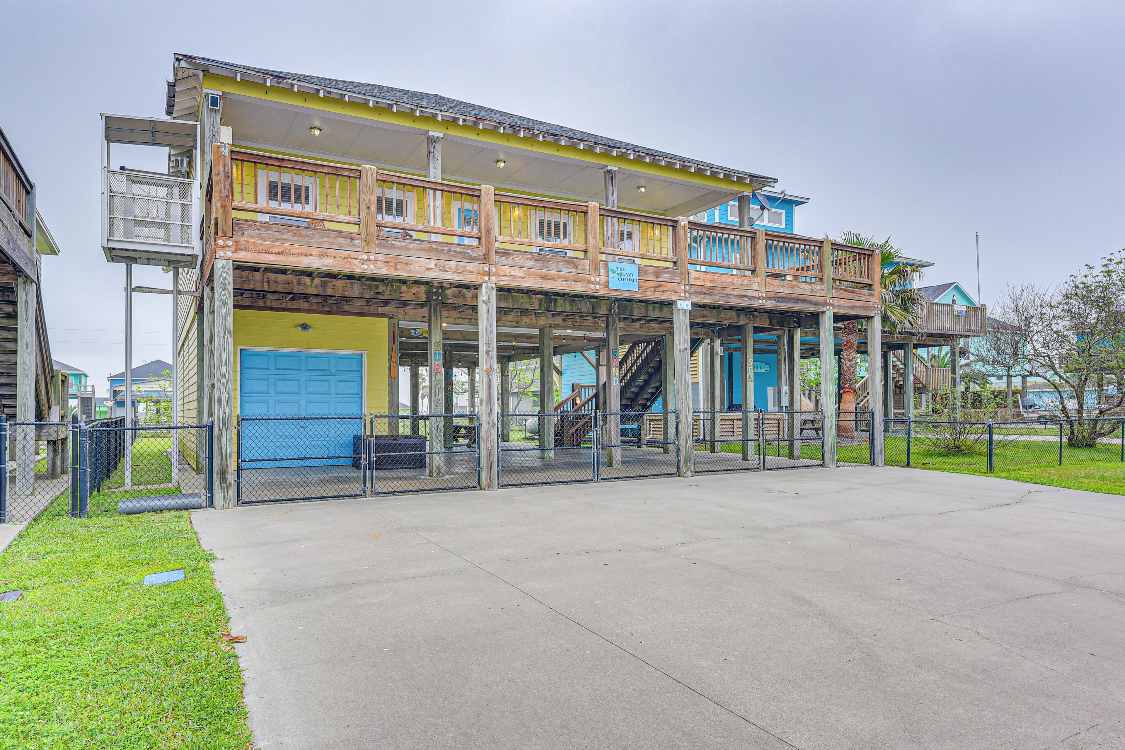 A two-story building with a covered outdoor area and a blue garage door.