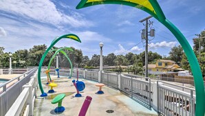 A playground with colorful equipment, a fenced area, and a clear sky. - Updated Ybor City House w/ Fenced Yard (Tampa)