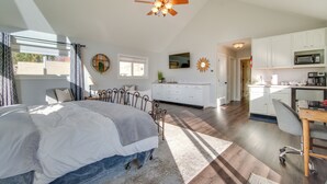 A bedroom with a bed, a desk, and a kitchenette. - Charming Getaway, Walk to Windsor Lake & Downtown! (Windsor)