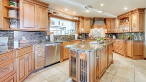 A spacious kitchen with wooden cabinets, granite countertops, and stainless steel appliances. - 2 Mi to Old Town: 'the Grand Palms Estate' w/ Pool (Scottsdale)