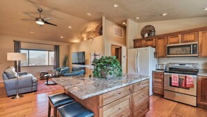 A spacious kitchen with wooden cabinets, a granite countertop, and stainless steel appliances. - Secluded Sedona Escape w/ Patio & Red Rock Views! (Sedona)