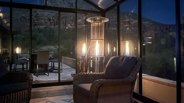 A balcony with wicker chairs, a table, and a tall, cylindrical lamp. - Secluded Sedona Escape w/ Patio & Red Rock Views! (Sedona)