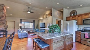 A spacious kitchen with a large island, wooden cabinets, and modern appliances. - Secluded Sedona Escape w/ Patio & Red Rock Views! (Sedona)