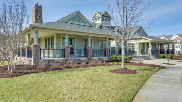 A two-story house with a stone chimney, a covered porch, and a well-maintained lawn. - 4 Mi to Beaches: Luxe Coastal Resort Condo (Lewes)