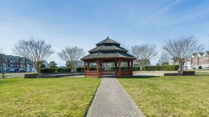 A gazebo in a park with a brick pathway leading to it, surrounded by grass and trees. - 4 Mi to Beaches: Luxe Coastal Resort Condo (Lewes)
