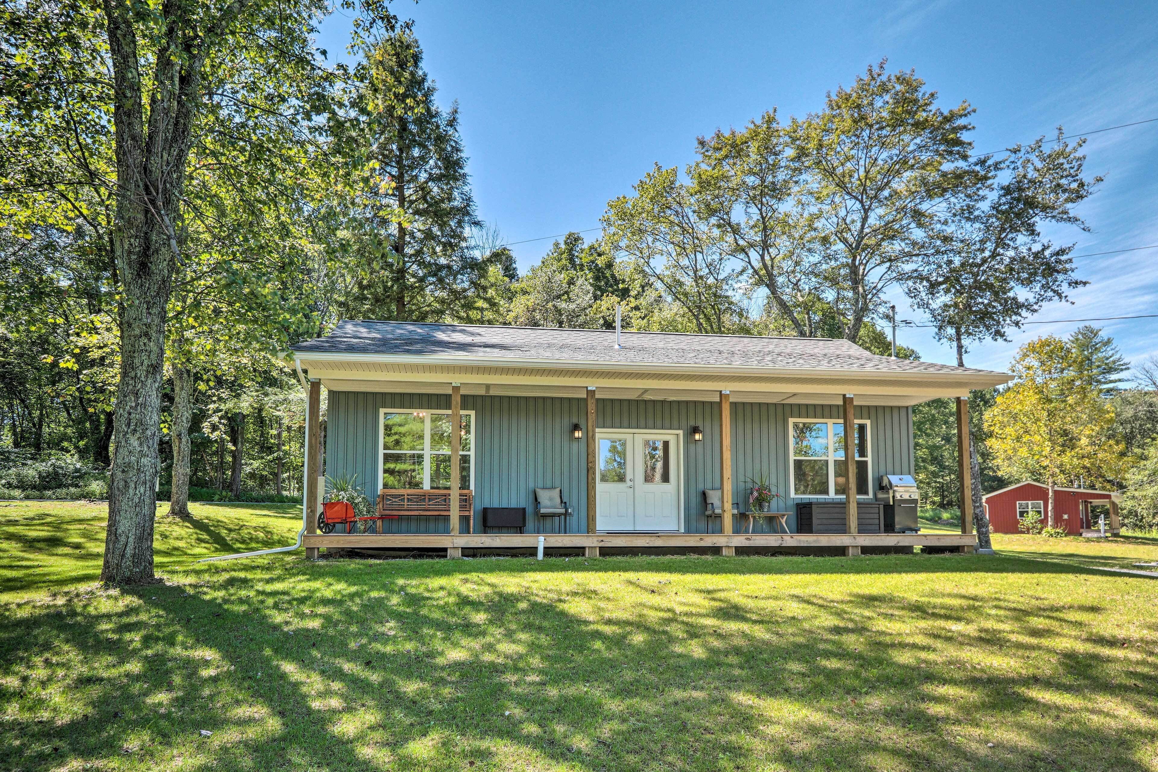 A single-story house with a porch, a door, and a small deck area.