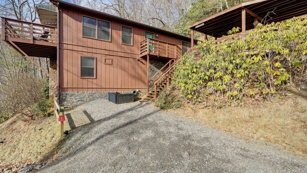 A rustic cabin with a wooden exterior, a front porch, and a staircase leading to an upper level. - 1 Mile to Golfing: Porch w/ Fireplace + Mtn Views! (Maggie Valley)
