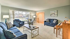 A living room with a sofa, armchairs, a coffee table, and a piano. - Spacious Family Glenwood Estates Home w/ Hot Tub! (Glenwood)